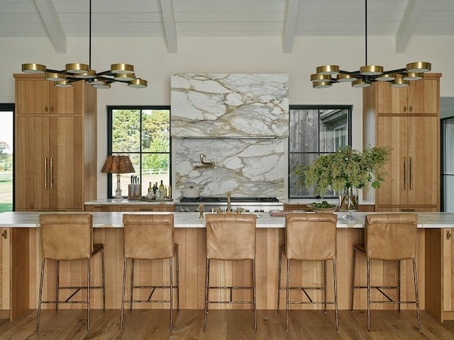76 N St, Kennebunkport, ME 04046 - kitchen featuring brown cabinets, beamed ceiling, and a notable chandelier