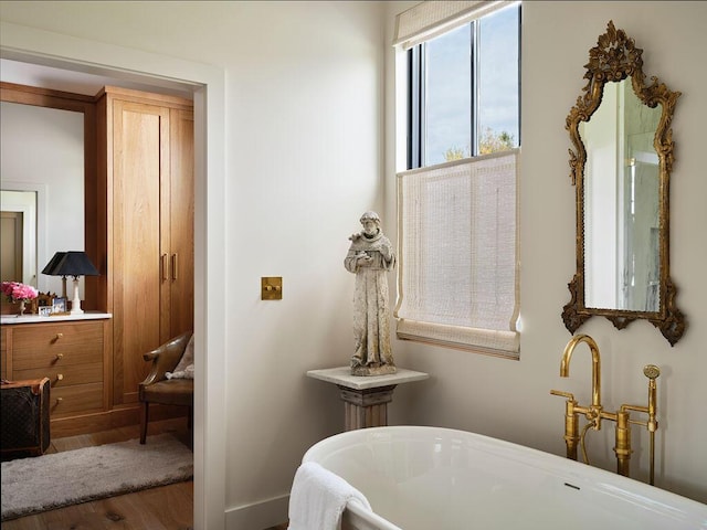 76 N St, Kennebunkport, ME 04046 - full bathroom featuring a freestanding tub and wood finished floors
