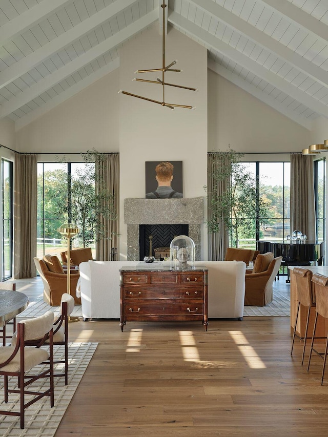76 N St, Kennebunkport, ME 04046 - living area featuring high vaulted ceiling, a notable chandelier, wood finished floors, and a fireplace