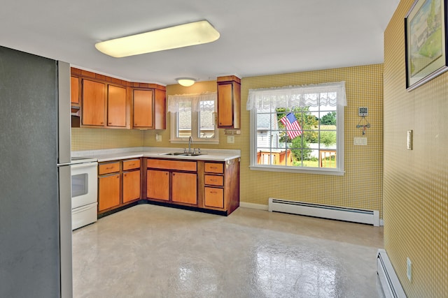 kitchen with white stove, decorative backsplash, sink, and a baseboard heating unit