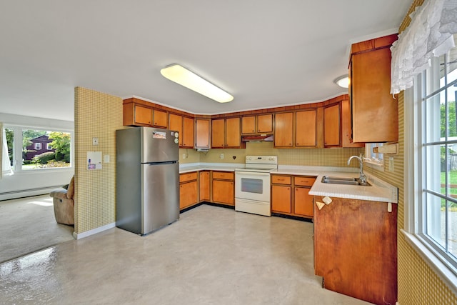 kitchen featuring plenty of natural light, white electric range oven, sink, and stainless steel refrigerator