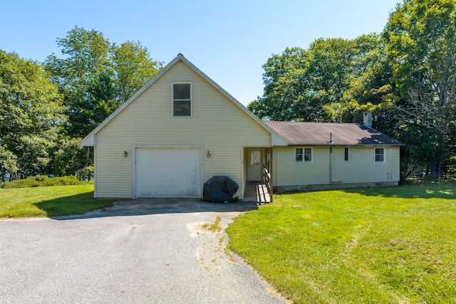 view of front of home featuring a garage and a front yard