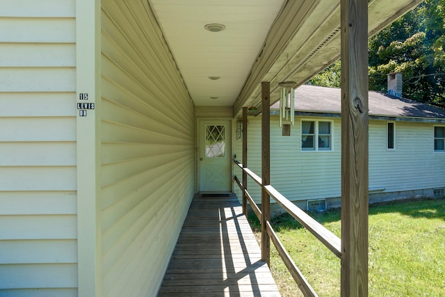 entrance to property with a lawn