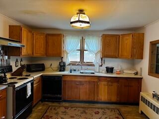 kitchen featuring black appliances, sink, radiator heating unit, and extractor fan