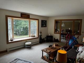 carpeted living room featuring baseboard heating