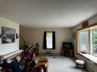 carpeted living room with a baseboard heating unit