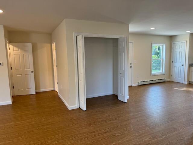 interior space featuring dark wood-type flooring and baseboard heating