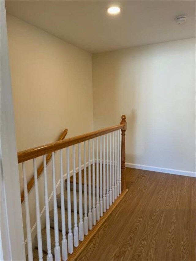 stairway featuring hardwood / wood-style flooring