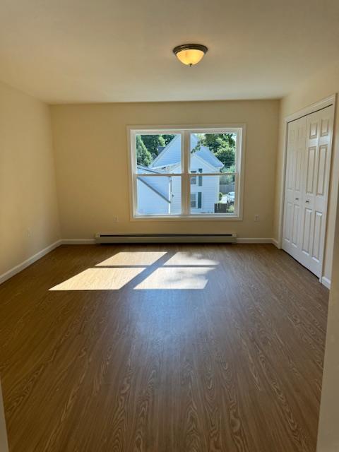 unfurnished room with dark wood-type flooring