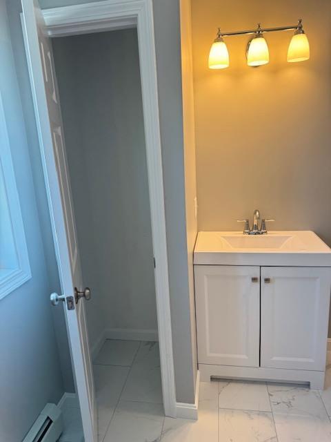 bathroom with a baseboard heating unit and vanity