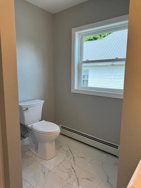 bathroom with a baseboard heating unit and toilet