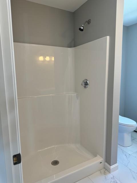 bathroom with toilet and walk in shower