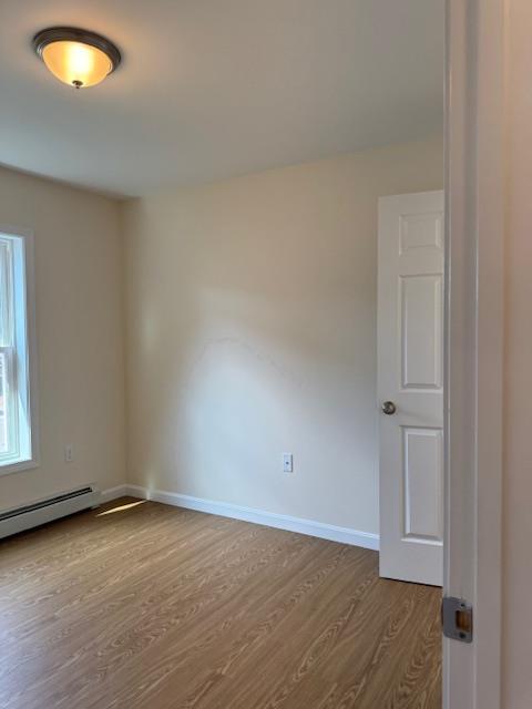 unfurnished room featuring wood-type flooring