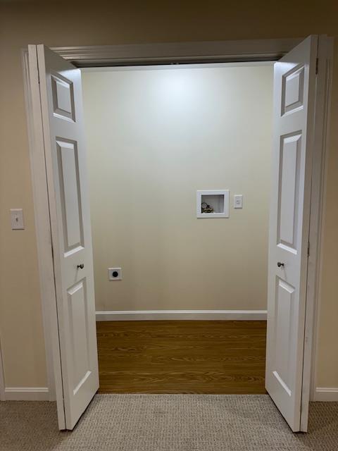 laundry area with hookup for a washing machine, electric dryer hookup, and light hardwood / wood-style floors