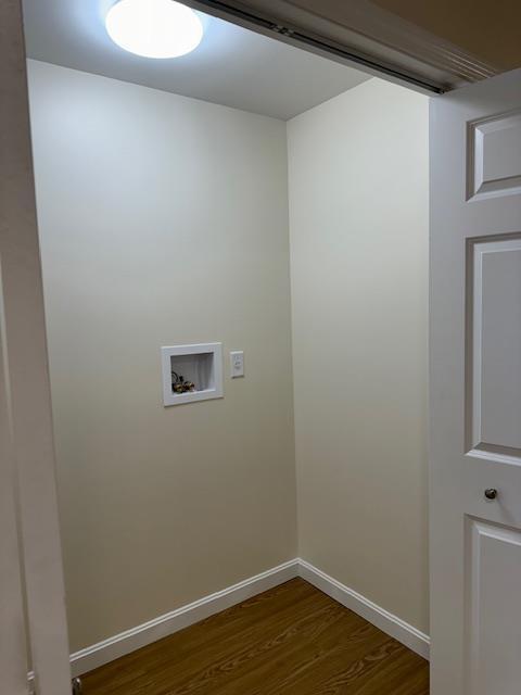 laundry area with dark wood-type flooring and hookup for a washing machine