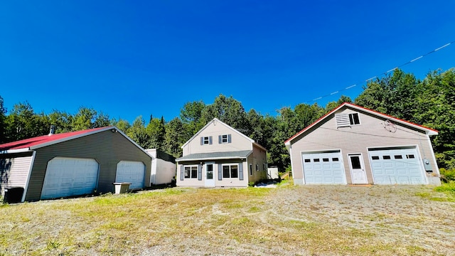 view of front of home with a front lawn, an outdoor structure, and a garage