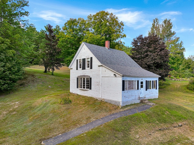 view of side of home with a lawn