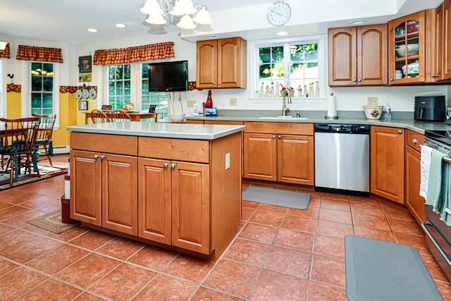 kitchen with plenty of natural light, a center island, sink, and stainless steel appliances