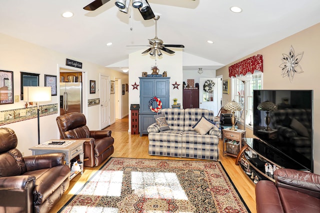 living room featuring vaulted ceiling and light wood-type flooring