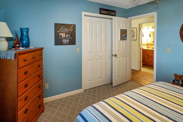 carpeted bedroom featuring connected bathroom and a closet