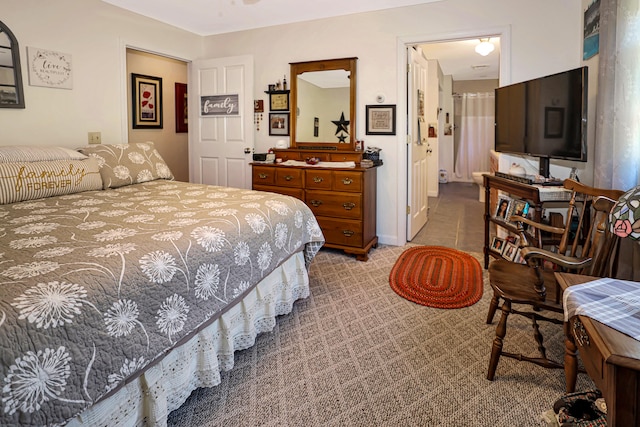 bedroom featuring light colored carpet and connected bathroom