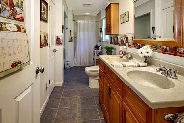 bathroom with tile patterned floors, vanity, and toilet