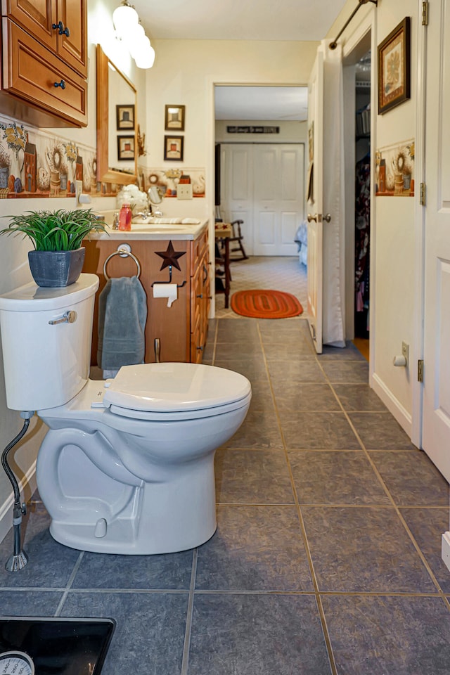 bathroom with tile patterned floors, vanity, and toilet