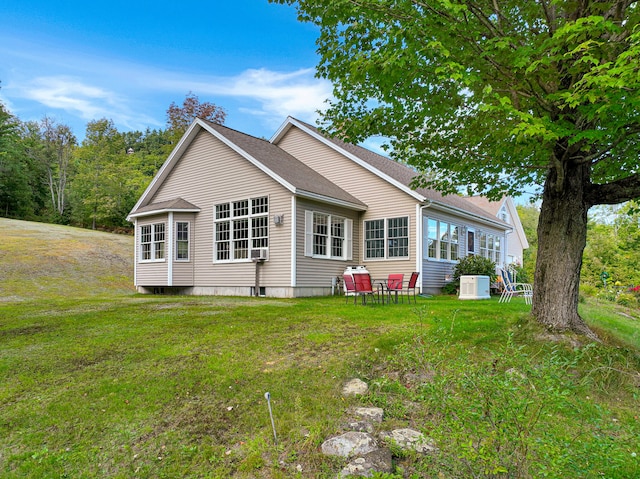 rear view of house featuring a lawn