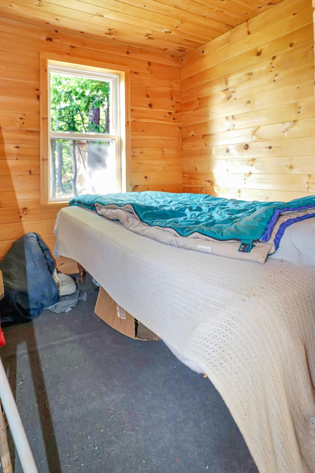 bedroom with wooden walls and wooden ceiling