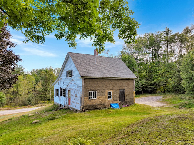 view of property exterior featuring a lawn