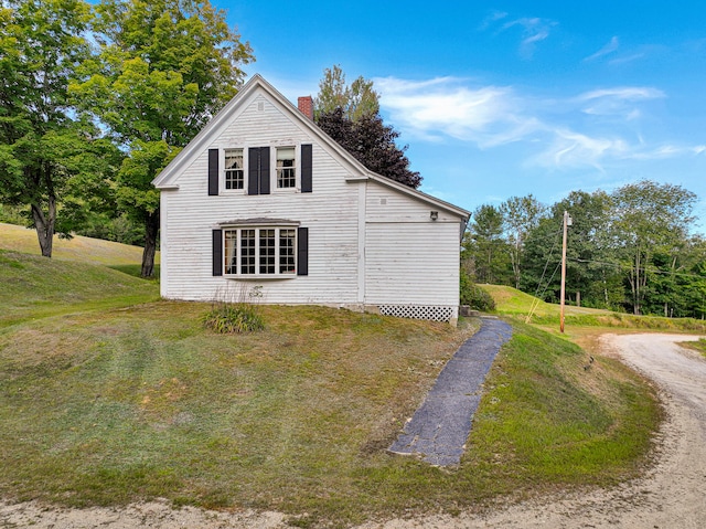 view of side of property with a lawn