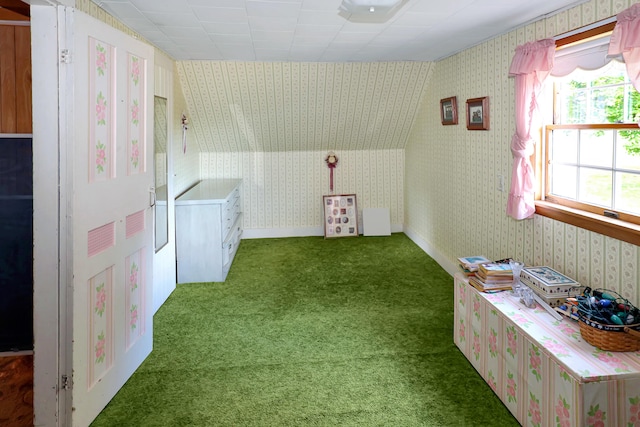 interior space featuring plenty of natural light, dark carpet, and lofted ceiling