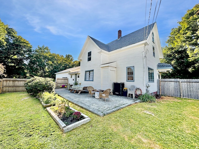 back of property with a lawn and a patio