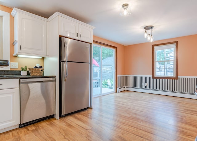 kitchen featuring white cabinetry, light hardwood / wood-style floors, appliances with stainless steel finishes, and a wealth of natural light