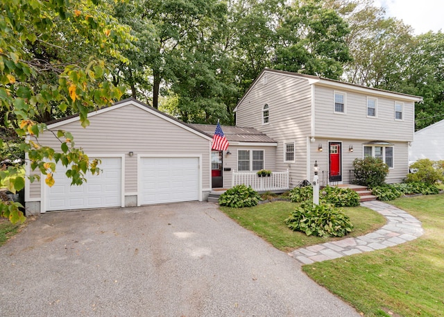 view of front of house with a garage and a front lawn