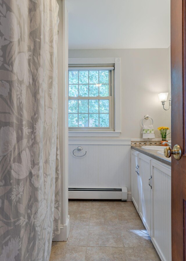 bathroom with vanity and a baseboard radiator