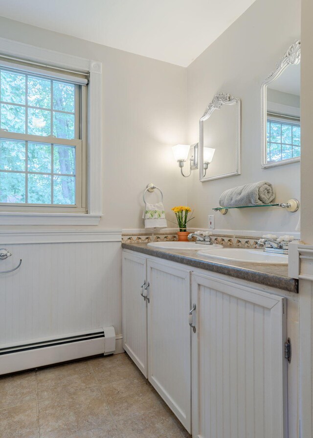 bathroom featuring vanity, a baseboard heating unit, and plenty of natural light