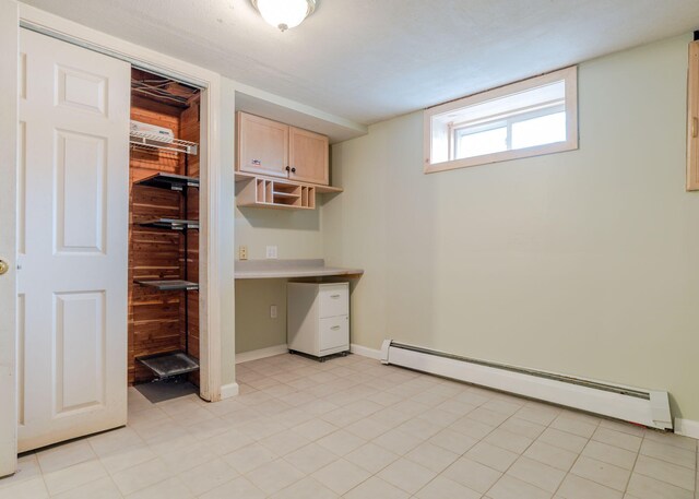 interior space featuring a baseboard heating unit and wood walls