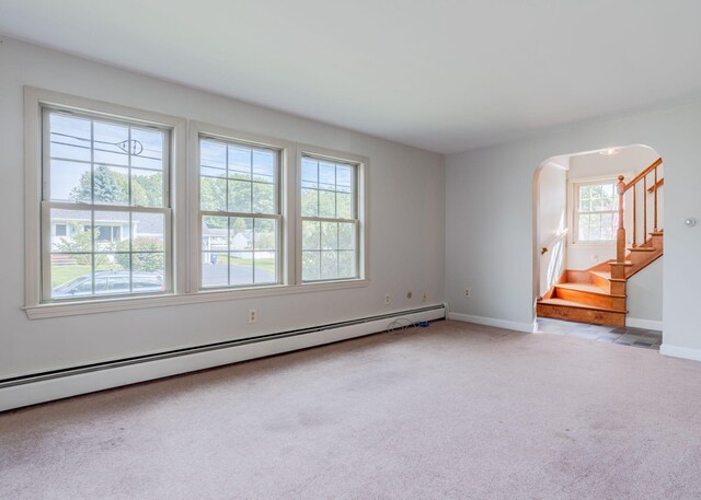 carpeted empty room featuring a baseboard radiator