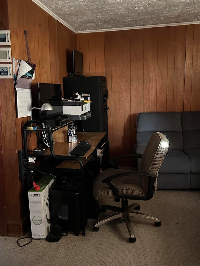 home office with crown molding, a textured ceiling, wooden walls, and carpet