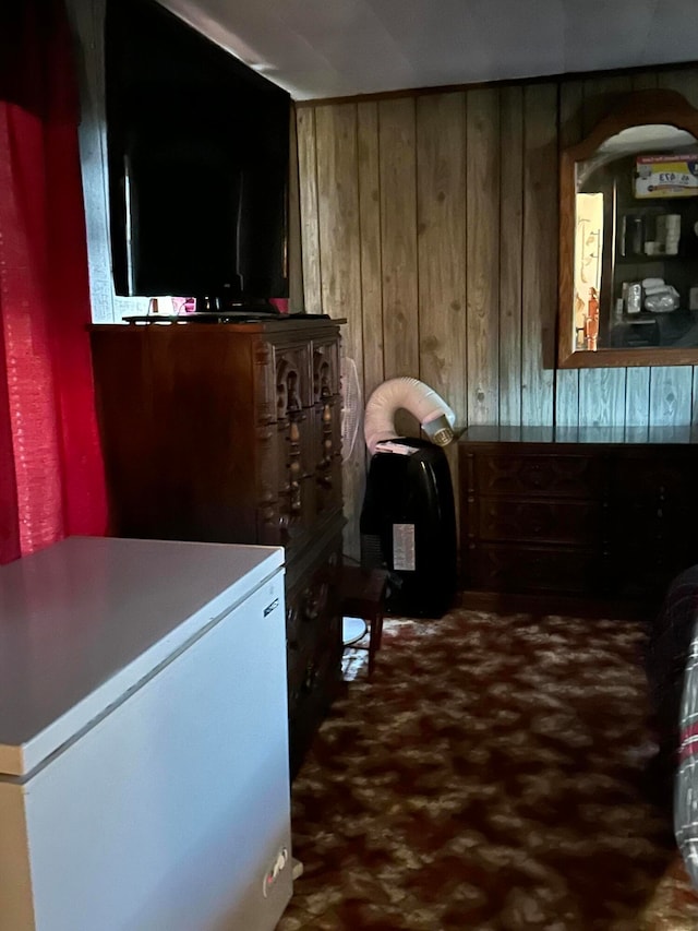 interior space with wood walls and white fridge