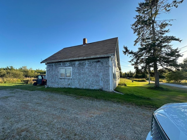 view of property exterior with a yard