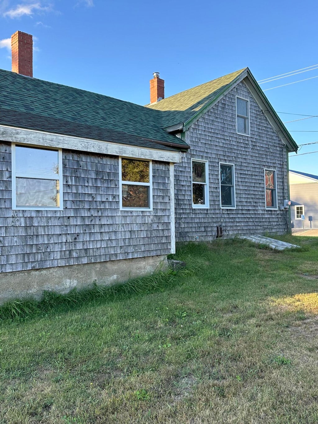 rear view of property featuring a lawn