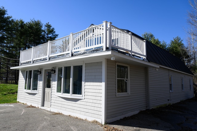 view of side of home with a balcony