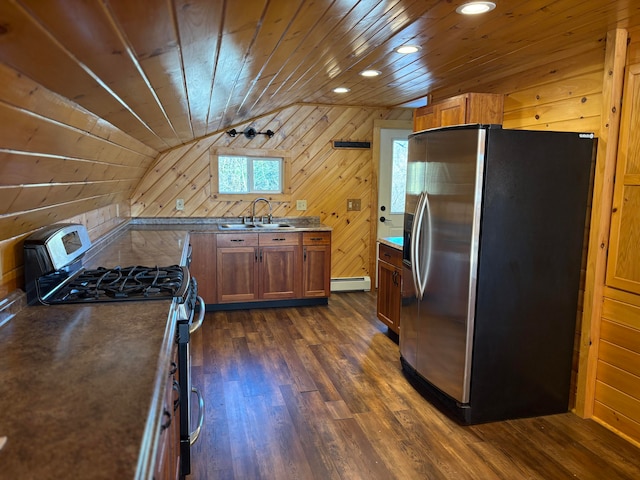 kitchen with appliances with stainless steel finishes, wooden walls, sink, a baseboard radiator, and wooden ceiling