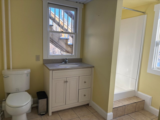 bathroom with a shower, tile patterned floors, vanity, and toilet