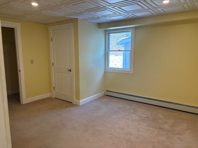 interior space featuring light carpet and a baseboard radiator