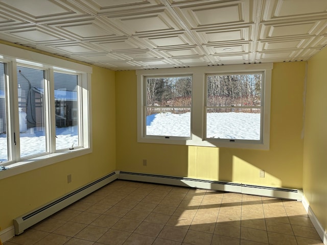 unfurnished room with light tile patterned floors and a baseboard heating unit