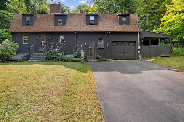 view of front of property featuring a garage and a front lawn