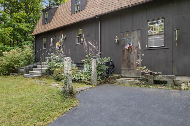 view of exterior entry with a lawn